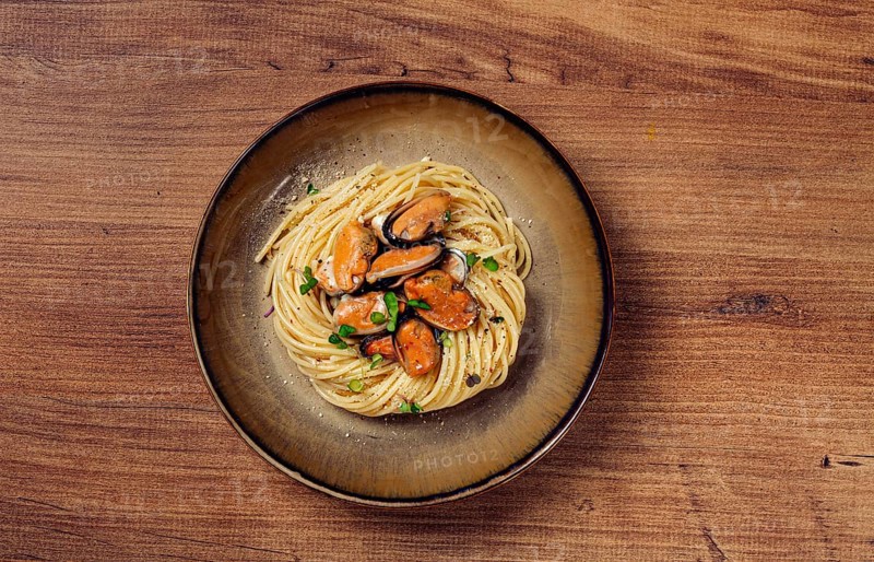Spaghetti with mussels, without shell, pasta with peeled mussels, in carbonara sauce, micro-greens, homemade, no people