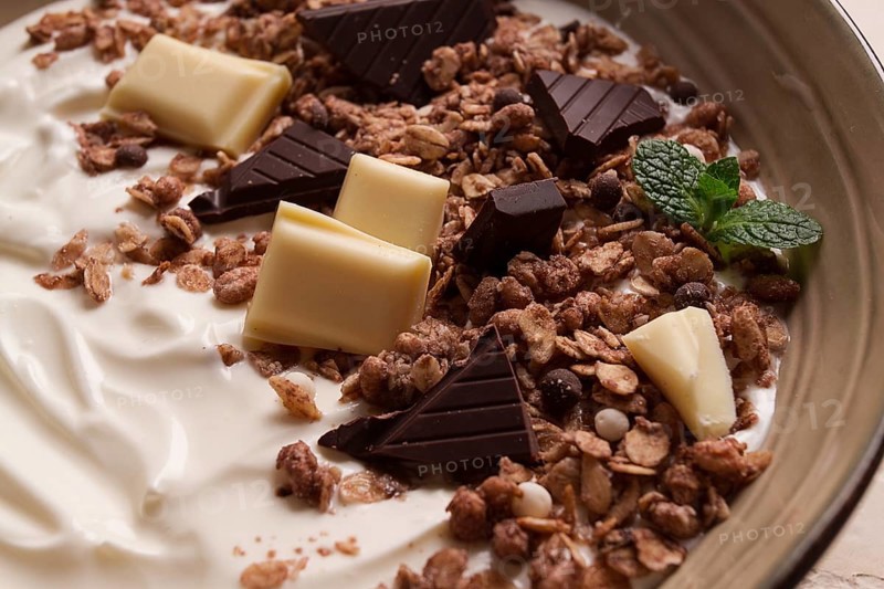 Yogurt with chocolate muesli, breakfast, close-up, fork on top, no people