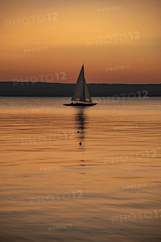 Sailing boat in the sunset with sunset on the Lake Ammer near Herrsching, Bavaria, Germany, Europe
