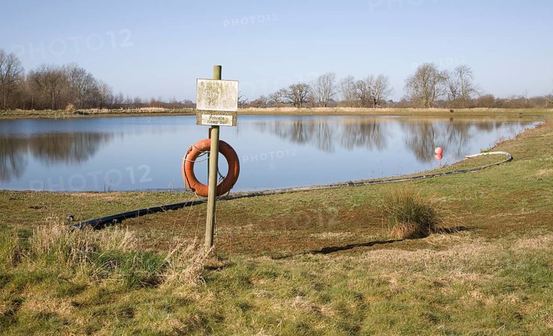 Orange life saving ring by irrigation water reservoir, Sutton, Suffolk, England, United Kingdom, Europe