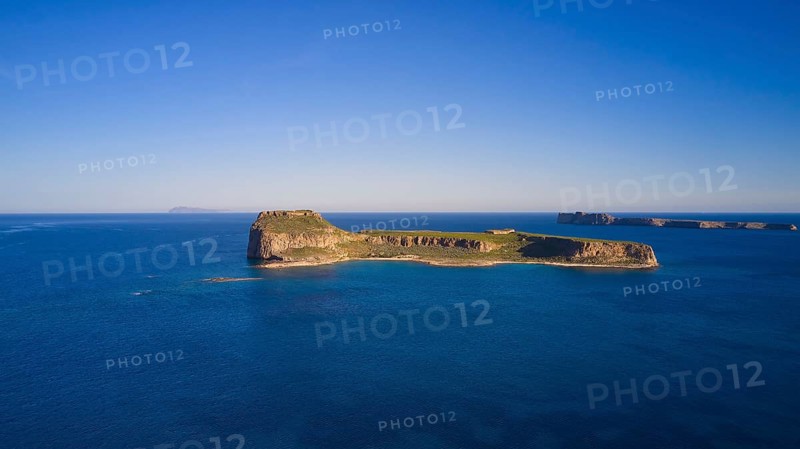 Drone shot, A deserted island in the vast blue ocean with rocky coastlines and clear skies, Venetian Sea Fortress, Gramvoussa, Gramvoussa Peninsula, Pirate Bay, Balos, Lagoon, Northwest Crete, Crete, Greek Islands, Greece, Europe