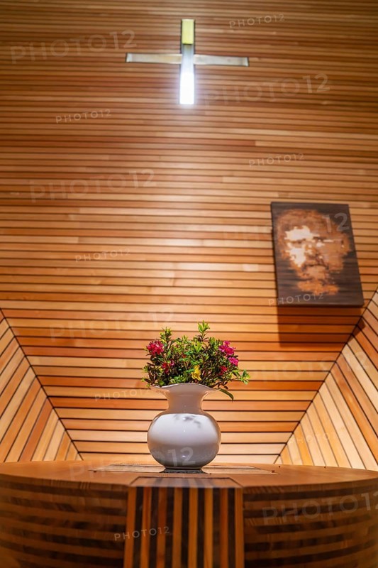 Flower arrangement on an altar table in a modern, wood-panelled interior with cross, Penken, Zillertal, Austria, Europe