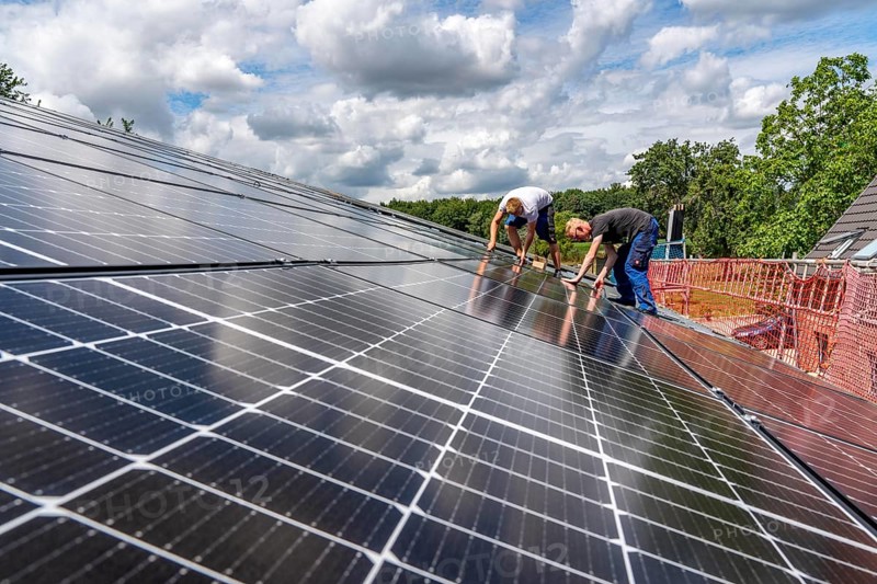 Installation of solar modules on the roof of a barn on a farm, over 210 photovoltaic modules are installed on the roof, North Rhine-Westphalia, Germany, Europe