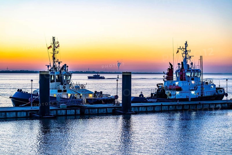 The tugboat pier, harbour tugs waiting for their next assignment, at the New Harbour, sunset over the Weser estuary with in Bremerhaven, Bremen, Germany, Europe