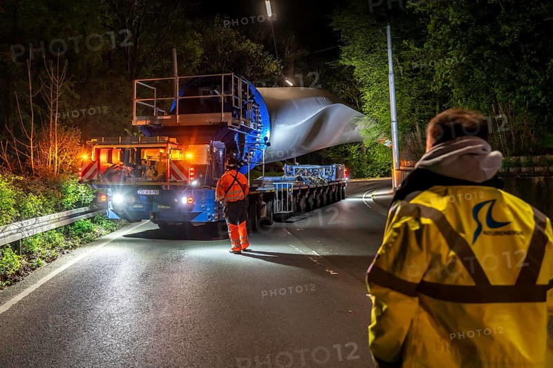 Transport of a 68 metre long, 22 tonne blade of a wind turbine, here in Schwelm, with a self-propelled Blade-Lifter vehicle, over a 40 km long route, over 2 nights, in the Bergisches Land, through towns, villages, over country roads, narrow through roads, to the construction site of the wind turbine near Hagen, North Rhine-Westphalia, Germany, Europe