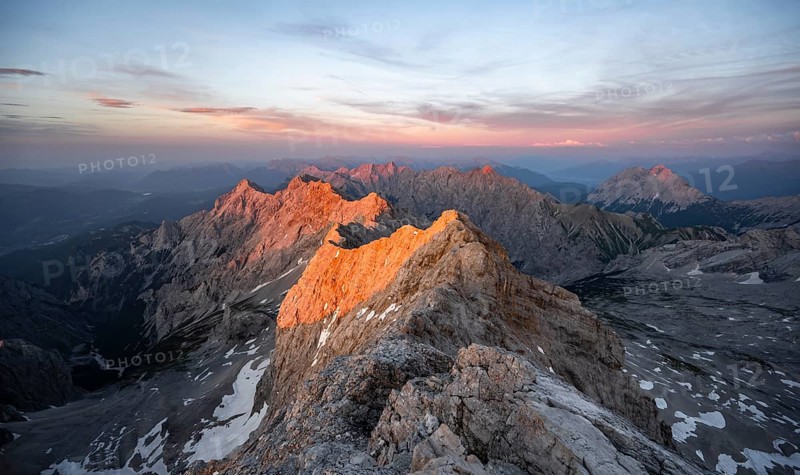 Impressive rocky mountain landscape, steep mountain ridge, Jubiläumsgrat with Alpspitze, mountain panorama from the summit of the Zugspitze, alpenglow at sunset, Northern Limestone Alps, Wetterstein Mountains, Bavaria, Germany, Europe