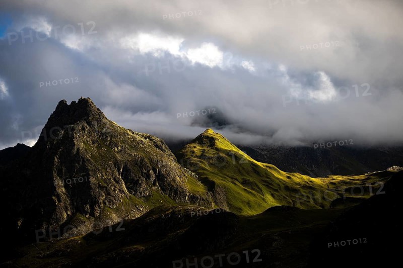 Grassy mountains with light mood and threatening clouds, Tschagguns, Rätikon, Montafon, Vorarlberg, Austria, Europe