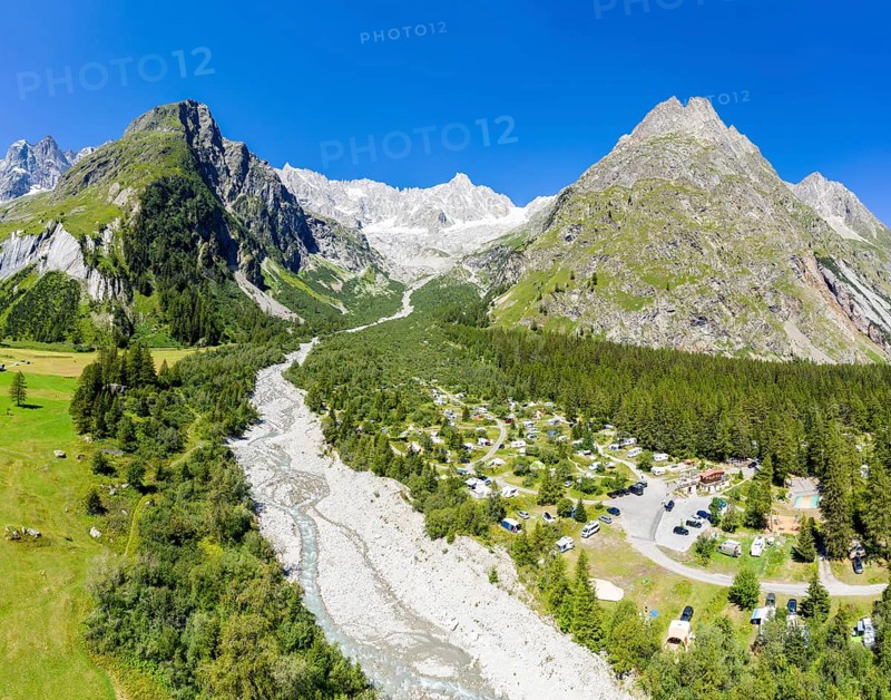 Panoramic aerial view of a campsite at a glacial river, mountain range with glacies in the back, La Fouly, Switzerland, Europe