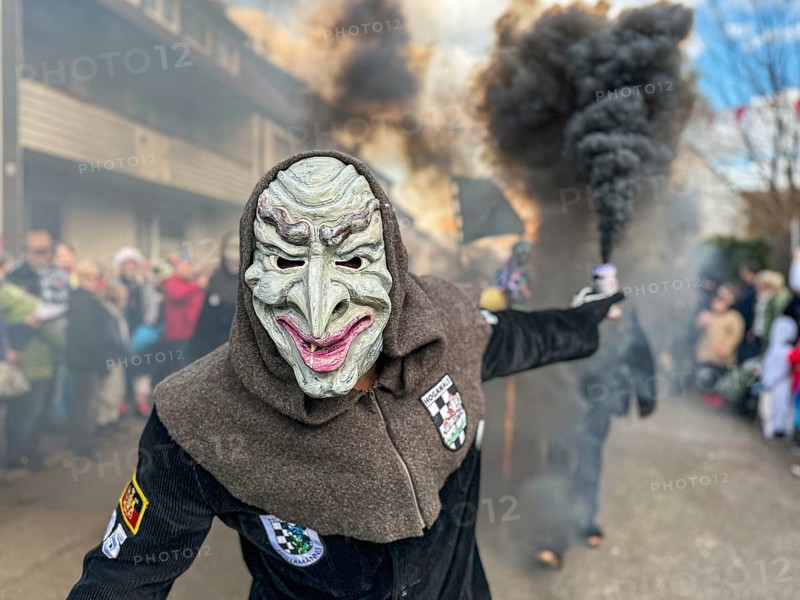 Portrait of Hofener Hogamale with smoke bomb at the big carnival parade of the Hofener Scillamännle, Hofen, Stuttgart, Baden-Württemberg, Germany, Europe