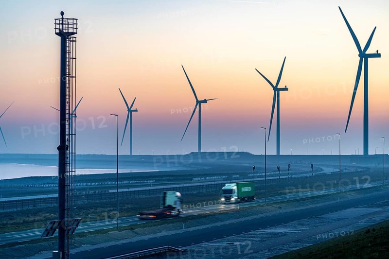 Lorry on the road to Euromax Terminal Rotterdam, ENECO wind farm on the dike around the port of Maasvlakte 2, 22 wind turbines with a capacity of 116 megawatts, sunset, Rotterdam, Netherlands