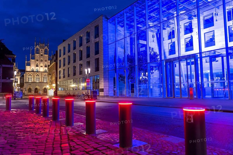 Historic old town, facade of the historic town hall, blue illuminated building of the Münster district government, illuminated barrier, bollards, in Münster, North Rhine-Westphalia, Germany, Europe