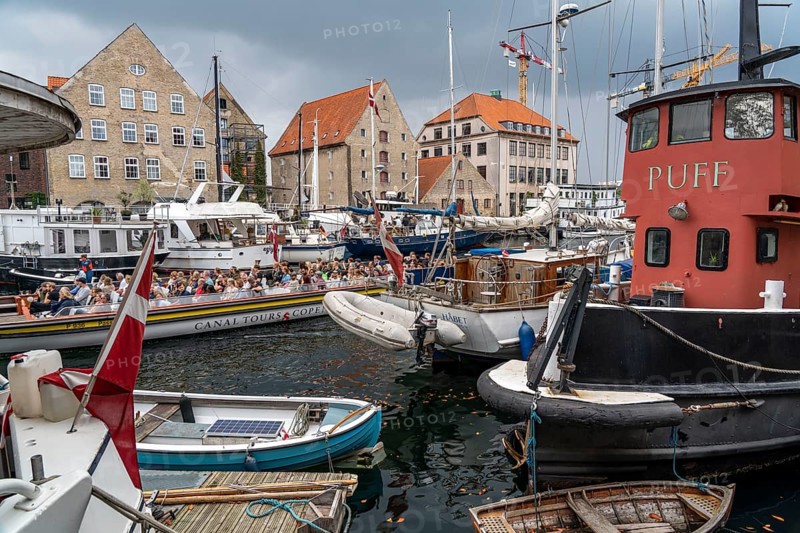 Ships and boats on Christianshavns Kanal, old district, at the same time very lively and hip neighbourhood, crossed by many canals, with shops, pubs, living space, Copenhagen, Denmark, Europe