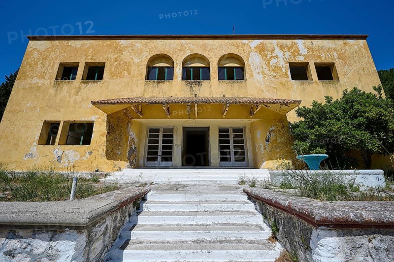An abandoned building with a crumbling façade and an external staircase on a sunny day under a blue sky, Lost Place, Former Santorium, Tuberculosis Centre 1947-1970, Former Italian Colonial Settlement, Eleousa, Campochiaro, Rhodes, Dodecanese, Greek Islands, Greece, Europe