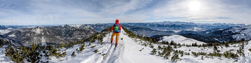 Ski tourer at the summit of Simetsberg, panorama with Walchensee, mountain panorama, Estergebirge, Bavarian Prealps, Bavaria Germany