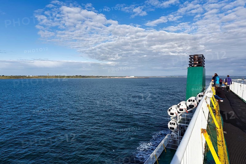 Passengers on a ferry between Ireland and Wales, view of the sea and coastline, spring clouds, Rosslare Harbour, Wexford, Ireland, Europe