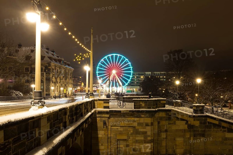 Christmas illumination on the Augustus Bridge in the snow with log cabin, Ferris wheel and steps, Dresden, Saxony, Germany, Europe