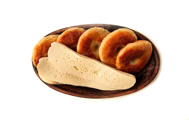 Mchadi, corn tortillas, traditional Georgian dish, corn bread, with Imeretian cheese, homemade, no people, on a light background
