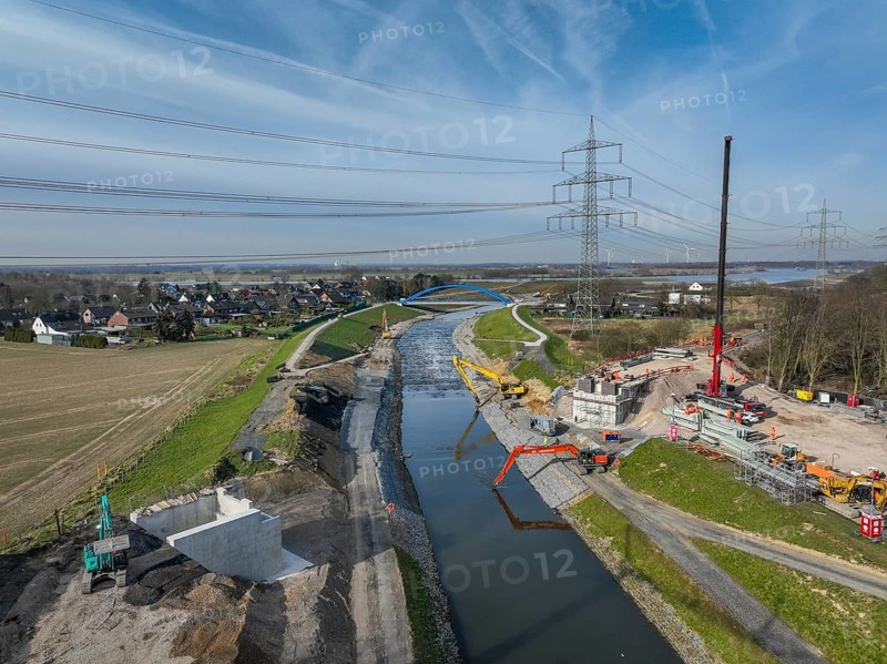 Dinslaken, Voerde, North Rhine-Westphalia, Germany - New Emscher estuary into the Rhine. New construction of the railway bridge and restoration of the dykes after dyke erosion during the 2023 flood. Renaturalisation of the Emscher. Flood protection through land expansion. The mouth of the Emscher into the Rhine was moved almost 500 metres north from Dinslaken to Voerde. Fish can now swim up the new Emscher from the Rhine through a newly created floodplain area without any barriers. Following the construction of a parallel sewer, the Emscher has been completely free of sewage since January 2022. The river was previously an open, above-ground combined sewer with rainwater and wastewater