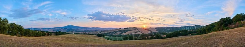 Typical Tuscan landscape in Val d'Orcia with hills, trees, fields, cypresses and farm road in autumn at sunset, La Foce, Tuscany, Italy, Europe