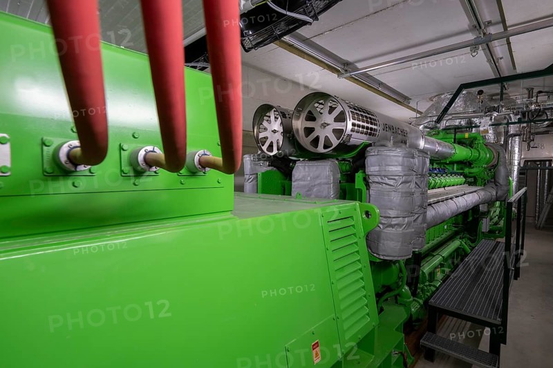 Biogas plant, gas-powered engine for electricity production, generator, in combined heat and power plant, the gas is produced from various biomass, including waste from the food industry, the electricity is produced in combined heat and power plants with the biogas produced and fed into the grid, the heat is sent to 70 households via a local heating network, part of the gas is processed and fed into the Thyssengas gas network, Anröchte, North Rhine-Westphalia, Germany, Europe
