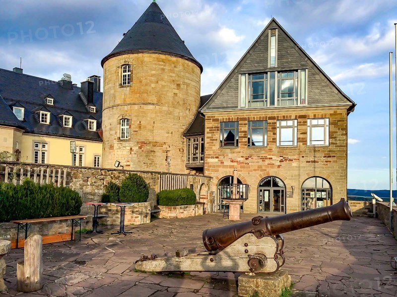 View from Altane to historical cannon in the foreground behind it on the right entrance to torture museum linka next to it castle tower of Waldeck Castle from 1120 Middle Ages 12th century, Waldeck, Hesse, Germany, Europe