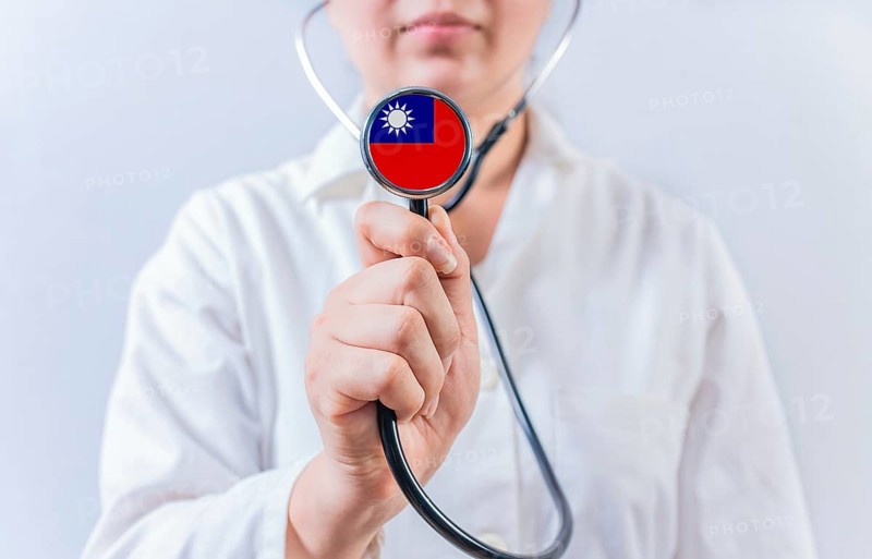 Female doctor holding stethoscope with Taiwan flag. National health system of Taiwan