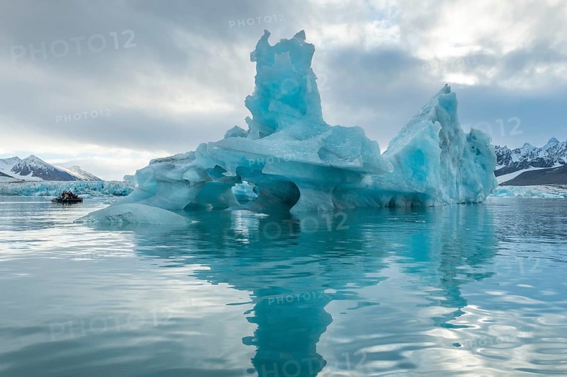 Dinghy with tourists, iceberg and glacier edge of Monacobreen, Liefdefjord, Woodfjord area, Spitsbergen Island, Svalbard and Jan Mayen archipelago, Norway, Europe