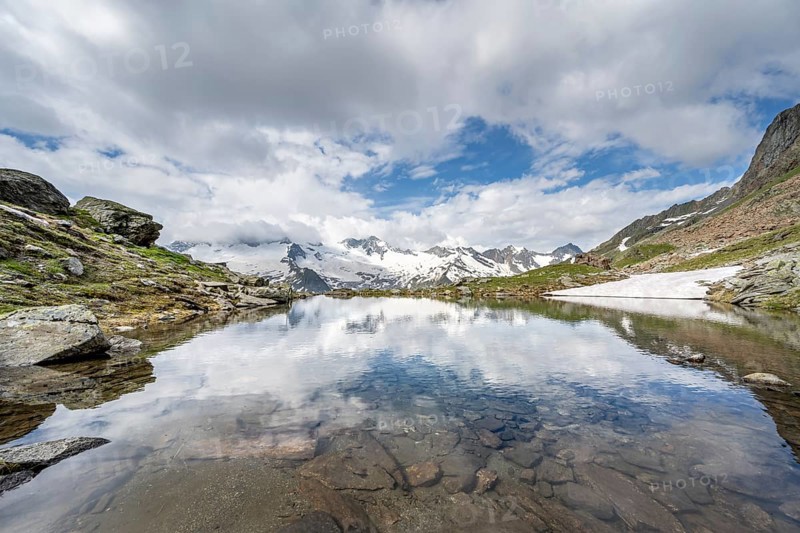 Picturesque mountain landscape with mountain lake, mountains and glaciers reflected in the Schwarzsee, Hornkees and Waxeggkees glaciers with Großer Möseler peak, Berliner Höhenweg, Zillertal Alps, Tyrol, Austria, Europe