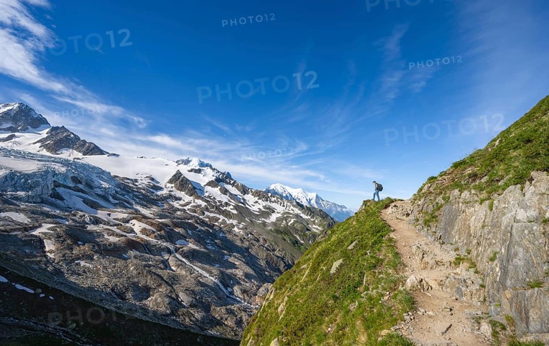 Mountaineer on a hiking trail, view of high alpine mountain landscape, summit of Aiguille de Chardonnet and Glacier du Tour, glacier and mountain peak, Chamonix, Haute-Savoie, France, Europe