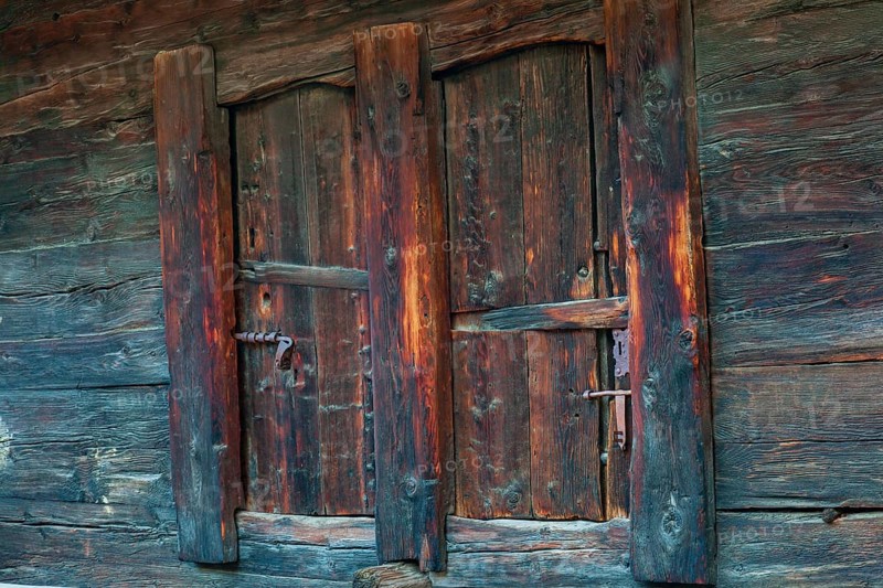 Closed wooden window shutter. Historic village of Mühlebach, Valais, Switzerland, Europe