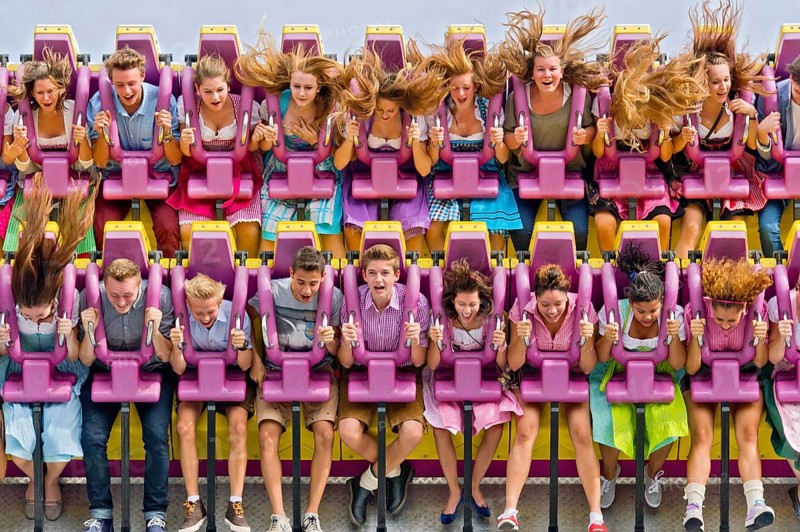 Boys and girls swinging with blowing hair in giant swing Top Spin Fresh, swing, ride on the Wies'n, Oktoberfest, Wiesn, Munich, Upper Bavaria, Bavaria, Germany, Europe