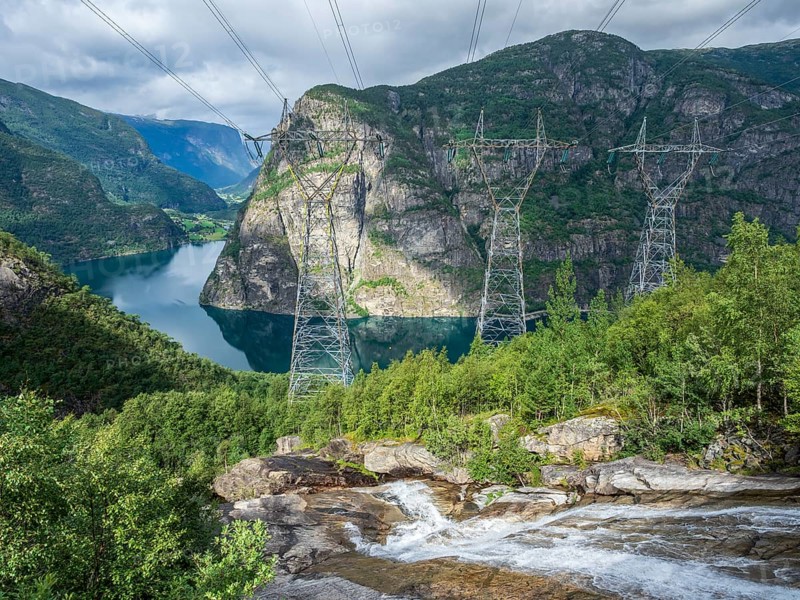 High voltage power lines above the Aurlandsfjord, a branch of the Sognefjord., transports electrical energy from multiple power station in the Aurland valley, Sognefjord region, Norway, Europe