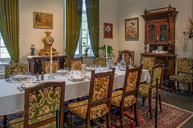 Dinner table with antique tableware in dining room inside 18th century clergy house Schriek at open air museum Bokrijk, Limburg, Flanders, Belgium, Europe