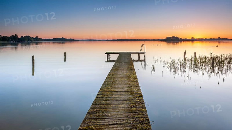Wooden footbridge at sunrise on Lake Schaalsee, Schaalsee Biosphere Reserve, Zarrentin, Mecklenburg-Western Pomerania, Germany, Europe