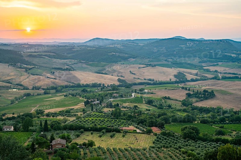 View from Montepulciano into a typical Tuscan landscape in Val d'Orcia with hills, trees, fields, cypresses and farm houses in summer, Montepulciano, Tuscany, Italy, Europe
