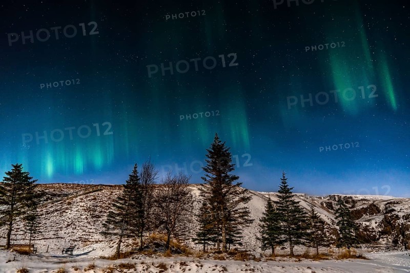 Beautiful image of a vibrant green and multi-colored Aurora Borealis, Aurora Polaris, also known as the Northern Lights in the night sky over Iceland