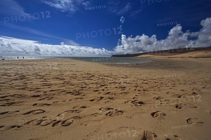 Beach Playa Risco del Paso, Playa de Sotavento with footprints in front of a cloudy blue sky, Pajara, Fuerteventura, Canary Islands, Spain, Europe