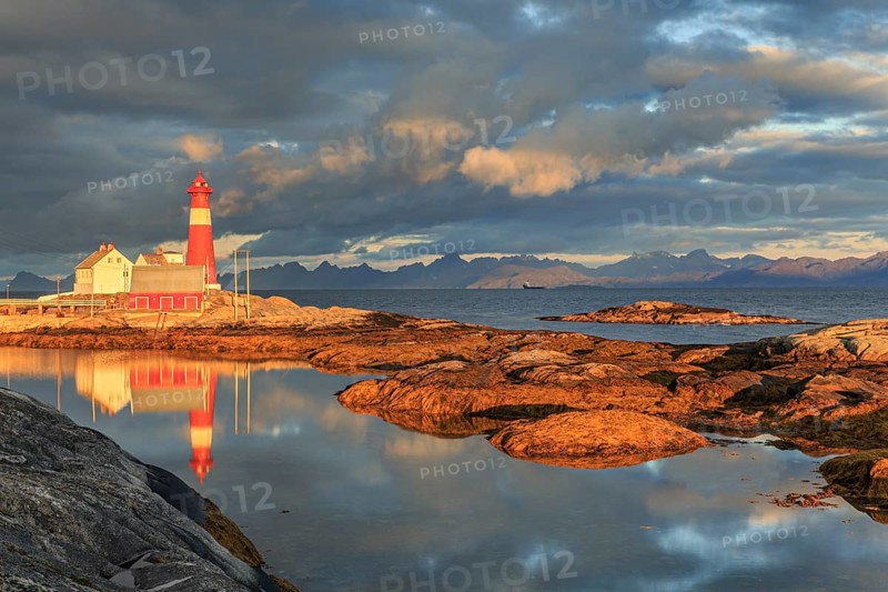 Lighthouse reflected in water, morning light, clouds, mountains, coast, Tranoy, Ofoten, Norway, Europe