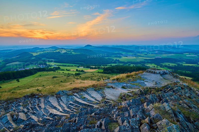 Colourful hilly landscape at sunset, showing fields and a dramatically coloured sky, Abtsroder Kuppe, Abtsroda, Wasserkuppe, Rhön, Hesse, Germany, Europe