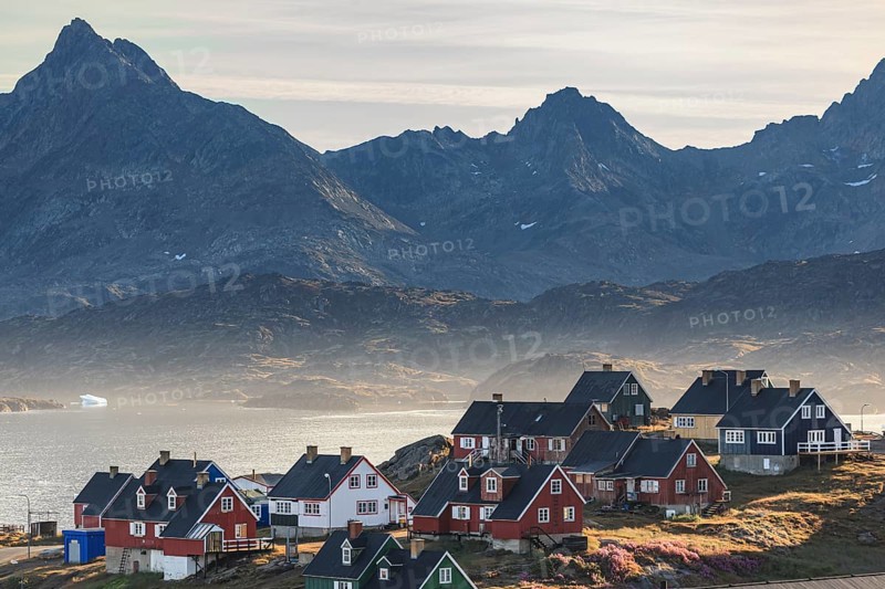Typical Greenlandic houses on a fjord with steep mountains, Inuit settlement, autumn, Tasiilaq, East Greenland, Greenland, North America