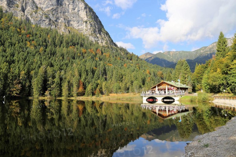 The picturesque Pflegersee lake near Garmisch, with the mountain inn in the background