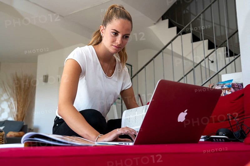 Young student learns at home, online, on her notebook