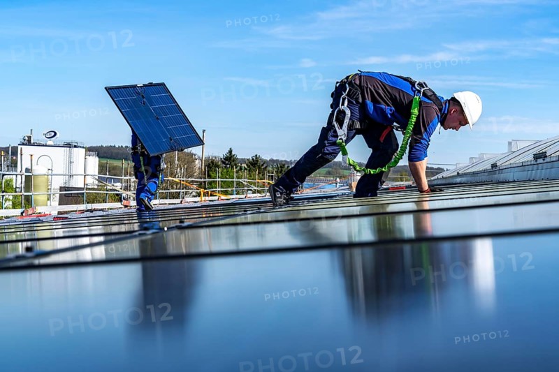 Installation of solar modules on the roof of a commercial enterprise, over 400 photovoltaic modules are installed on the roof, North Rhine-Westphalia, Germany, Europe