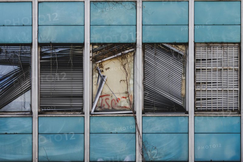Broken windows and shutters of an abandoned office building loom in Berlin, 29/02/2024
