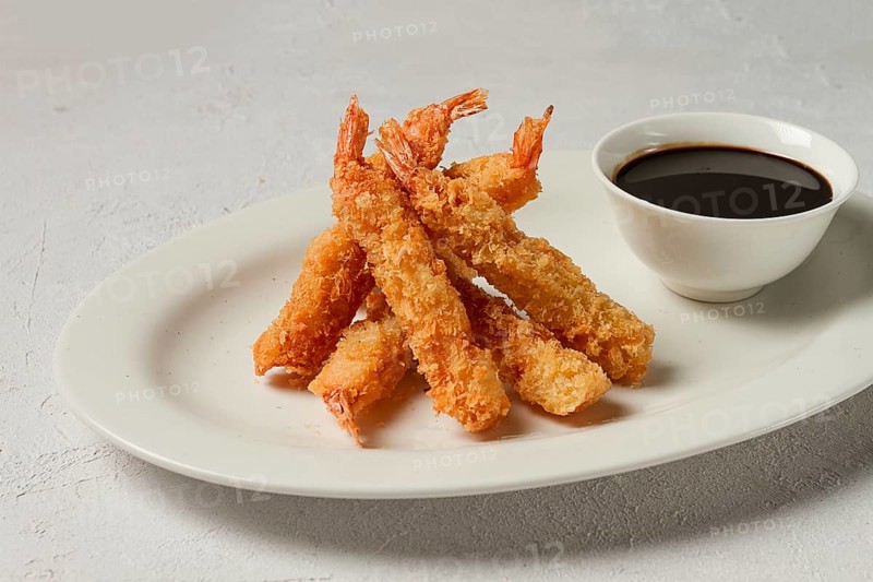 Fried shrimp, peeled in tempura, soy sauce, close-up
