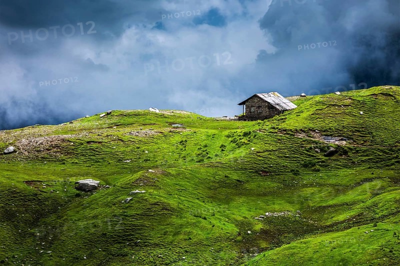 Serenity serene lonely scenery background concept, house in mountains on alpine meadow in clouds. Rohtang La pass, Himachal Pradesh, India, Asia