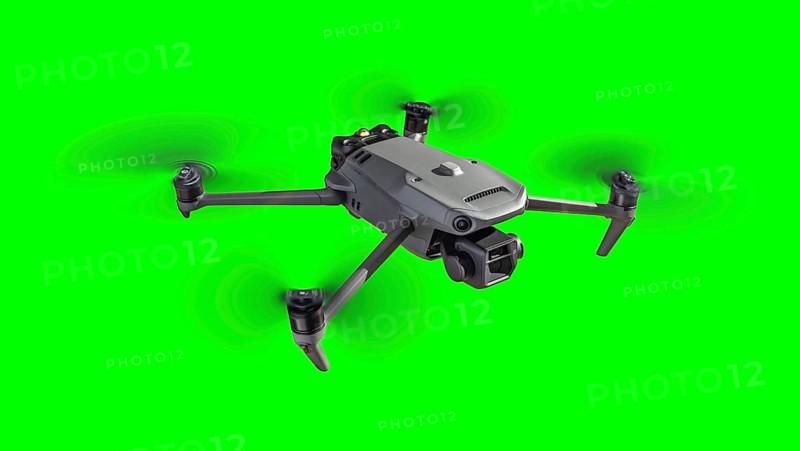 Isolated unmanned aircraft system (UAV) quadcopter drone in the air over A green screen