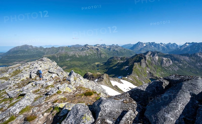 View of mountain landscape, mountain panorama, mountaineer at the summit of Rundfjellet, lake Hellskarvatnet, Svolvaer, Nordland, Norway, Europe