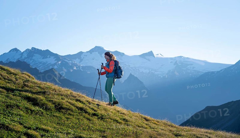 Hiker enjoying the mountain panorama in the morning, Venediger group, behind Dreiherrenkopf, Simonysitze and Großer Geiger, Hohen Tauern, Austria, Europe