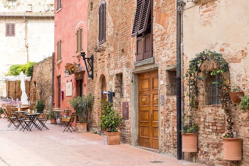 Cosy mix of old houses, shutters and street cafés in the old town of Certaldo, Tuscany, Italy, Europe